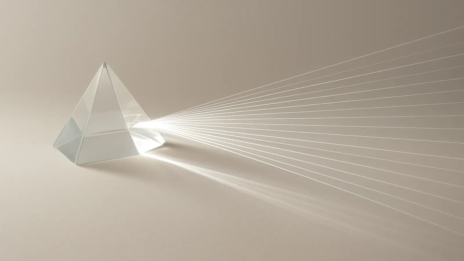 A single beam of light passing through a glass prism and fanning out into many thin rays across a pale surface.